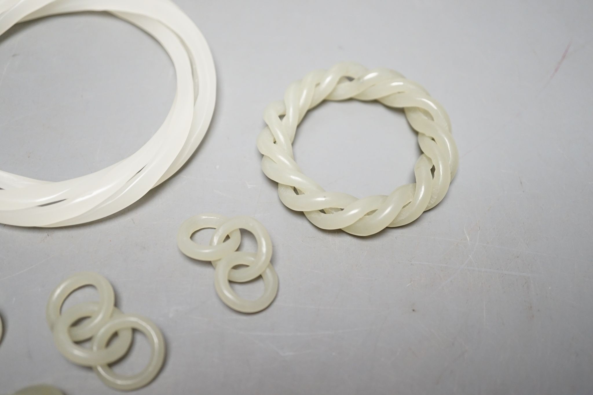 Two Chinese jade corded bangles, and four similar chain sections
